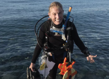 Carrie Atkins, in diving gear in the sea.